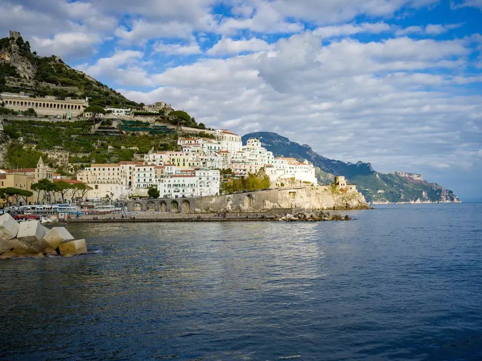 A view across the sea to the town of Amalfi and cliffs on the Amalfi Coast.
